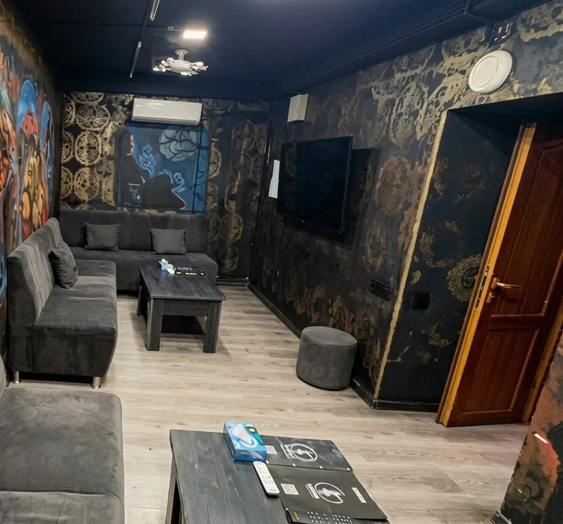 Long room with black and gold patterned walls
