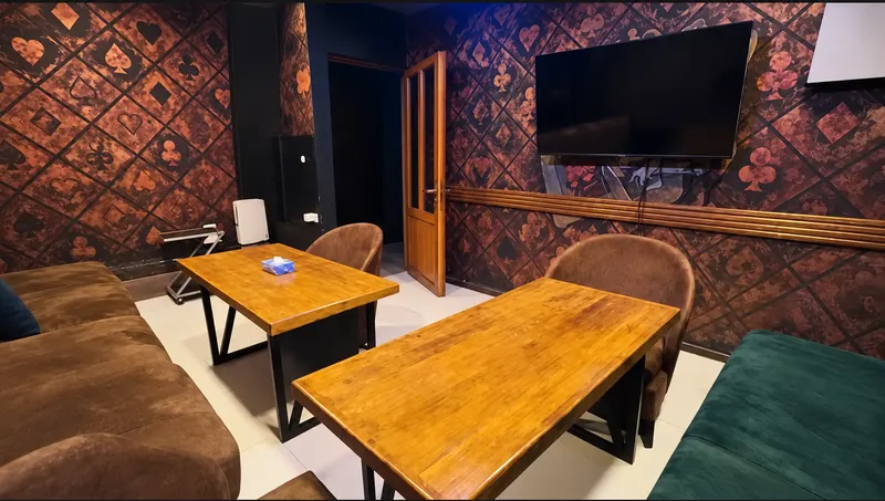 VIP Room 3 — card-suit walls, wooden tables and lounge seating
